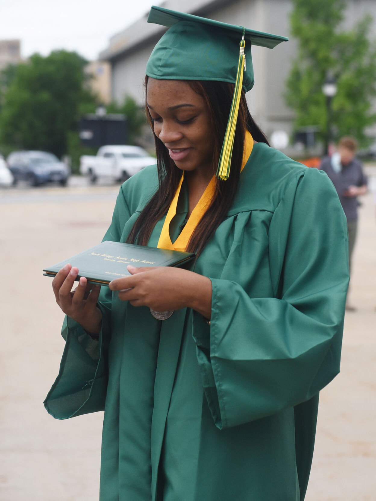 Aris Collier holds her diploma
